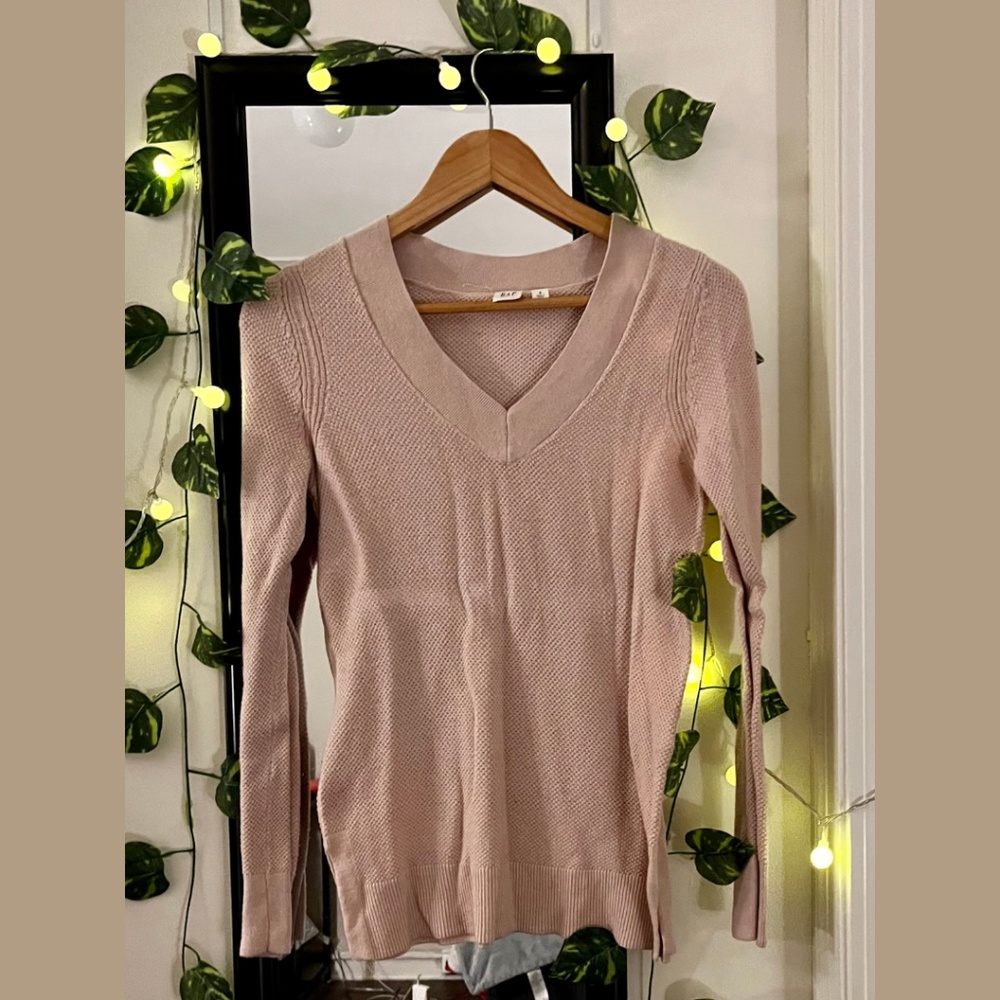 V-neck, light pink, soft, and snug top.